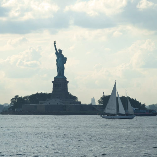 The Statue of Liberty & Sailing Boat View From The Water